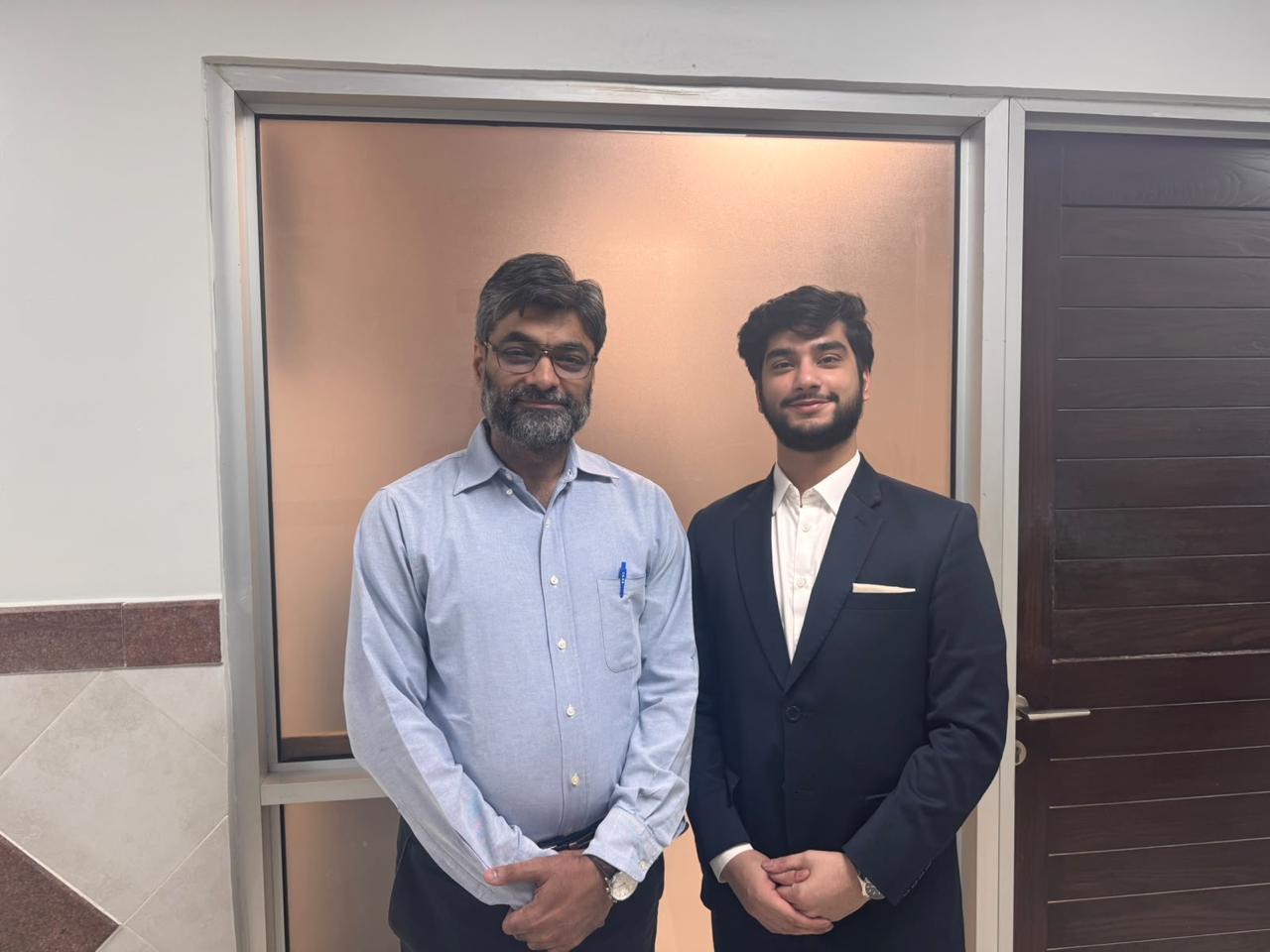 Two attendees in a corridor at Liaquat National Hospital after the session